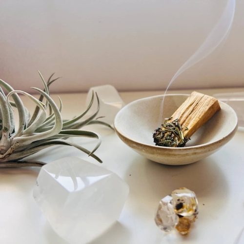 ark made mountain sage and rosemary dipped palo santo stick lit in bowl