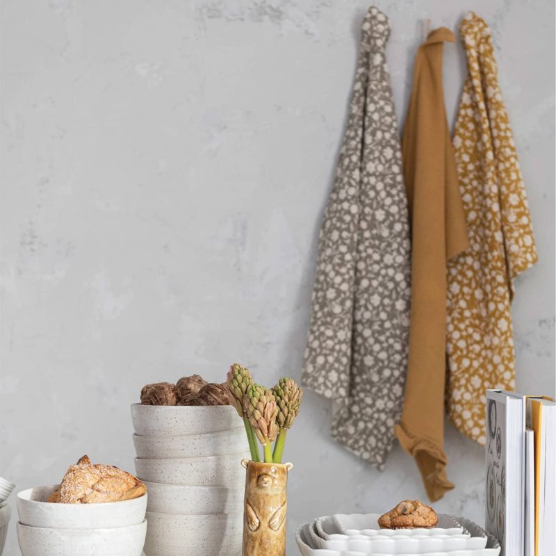 creative coop df8172a cotton slub and waffle tea towel sets in bmustard and tan hanging on wall