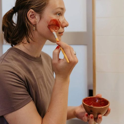 good flower farm flowers and rose clay botanical face mask woman applying to face