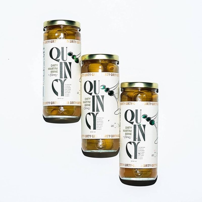 quincy olives and brine 3 jars on white